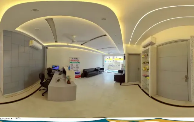 The reception and waiting area inside Dr. Ram's Physiotherapy Clinic, with the clinic's own signage on the wall.
